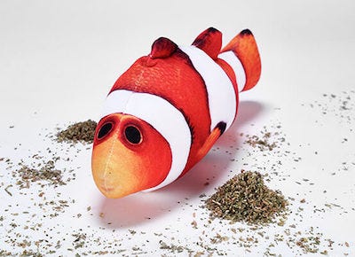 clownfish catnip toy laying next to piles of catnip