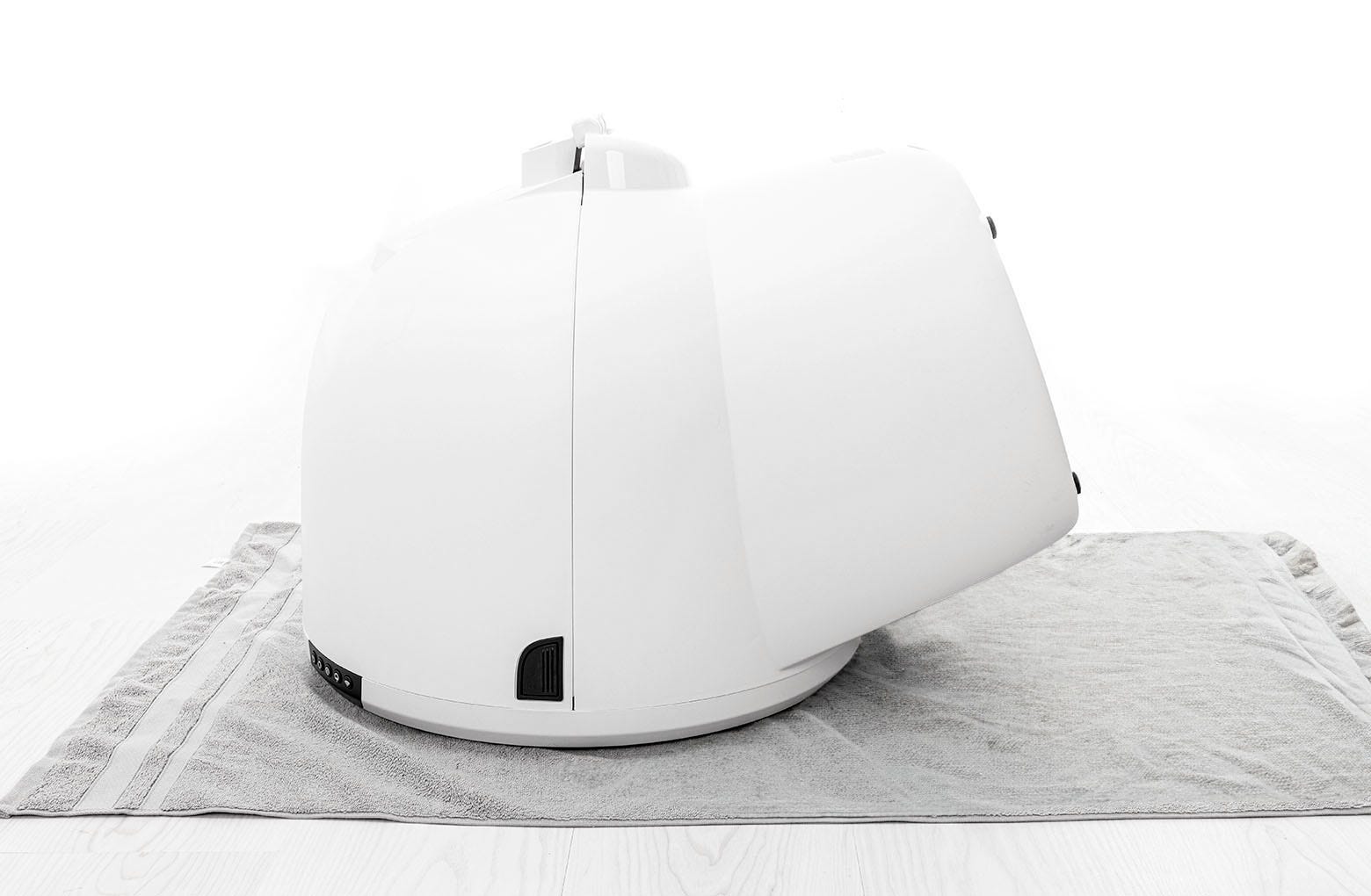 Image of Litter-Robot 4 laying facedown on a solid flat surface.