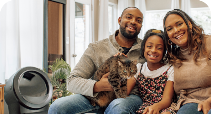 A family holding a cat.