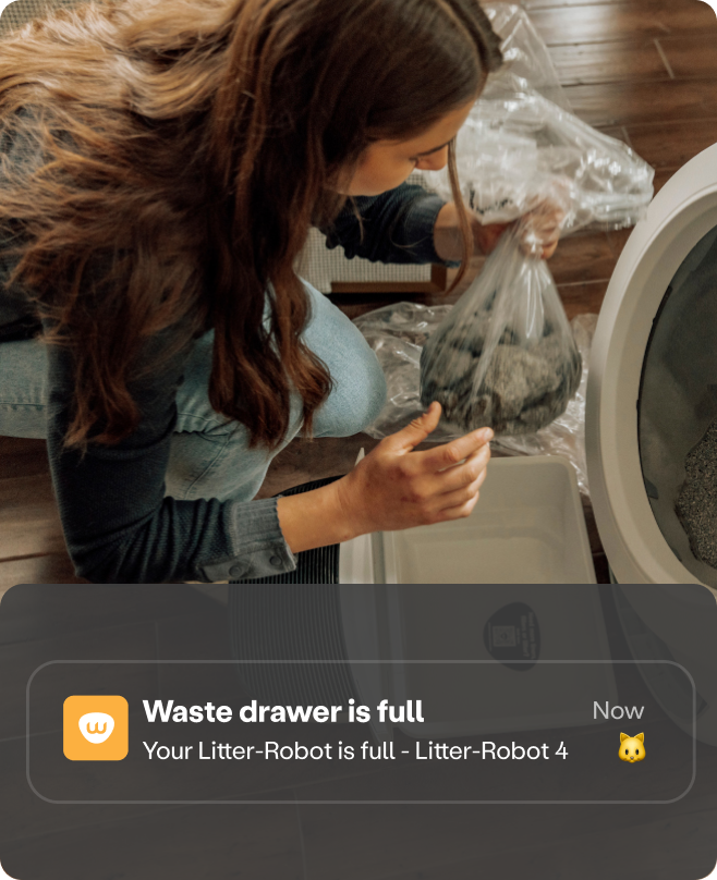 Woman emptying a Litter-Robot 4 waste drawer.