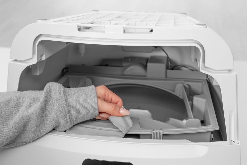 Duct tape peeling away from Litter-Robot waste port area