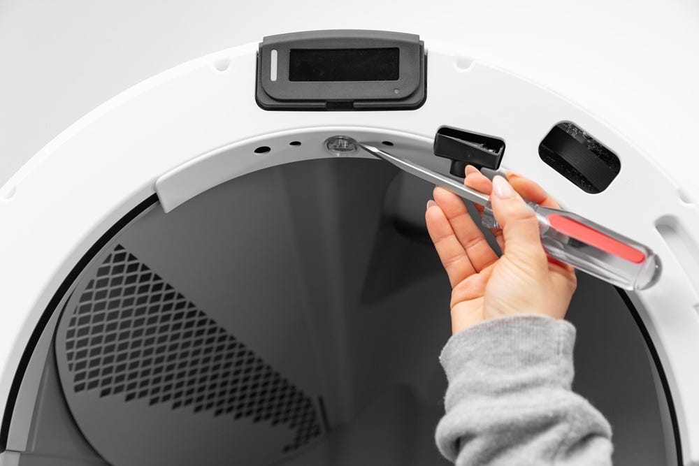Litter-Robot with screwdriver on the right side of the sensor